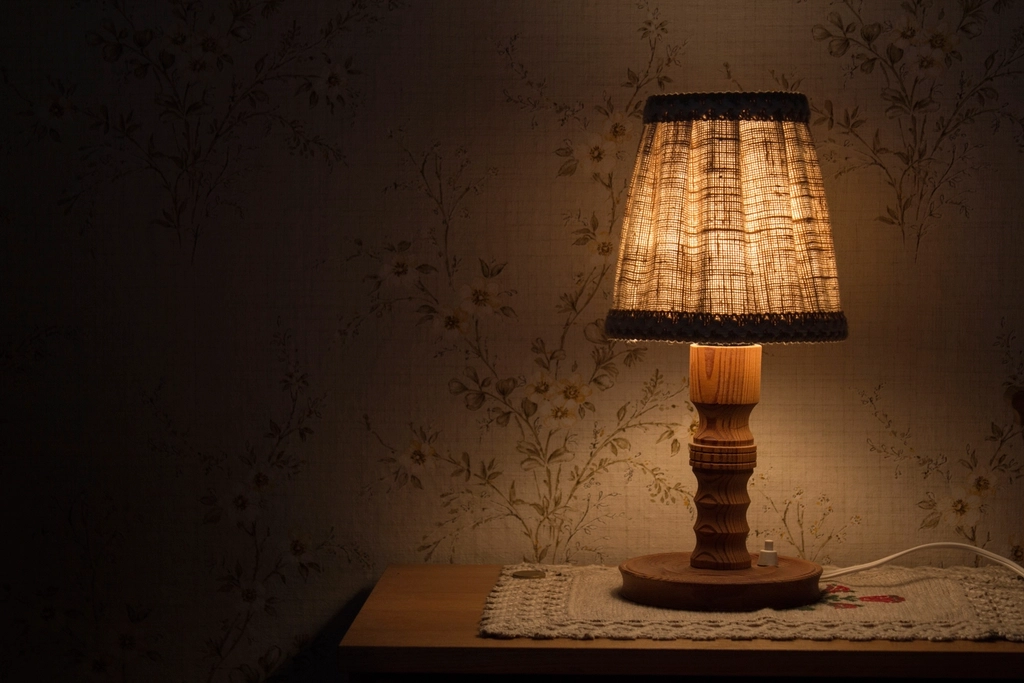 A lamp glowing in a dark room