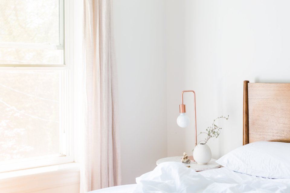 A bright bedroom with morning light at the window